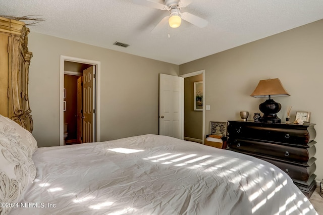 bedroom with visible vents, ceiling fan, and a textured ceiling