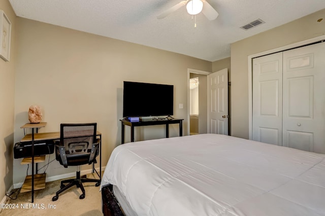 bedroom with a closet, visible vents, ceiling fan, a textured ceiling, and baseboards