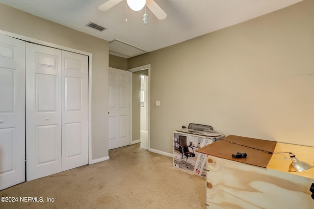 misc room with a textured ceiling, carpet, visible vents, and baseboards