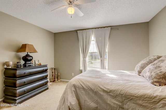 bedroom with carpet, baseboards, ceiling fan, and a textured ceiling