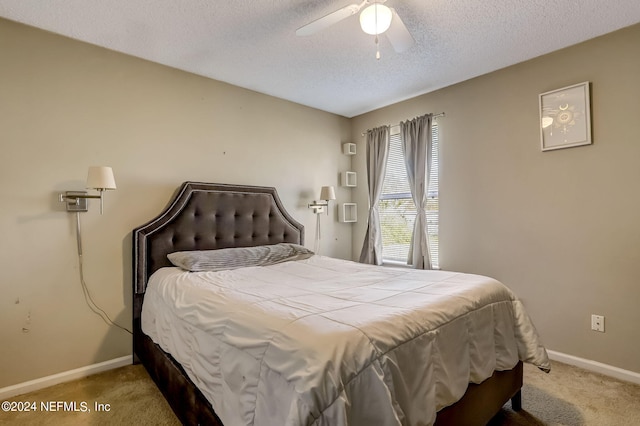 bedroom featuring carpet floors, a textured ceiling, baseboards, and a ceiling fan