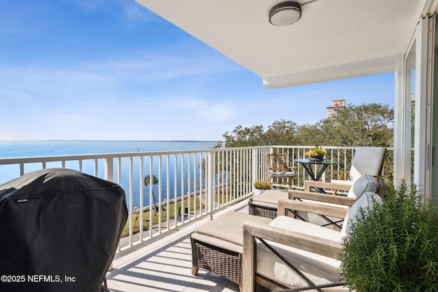 balcony with a water view and a grill