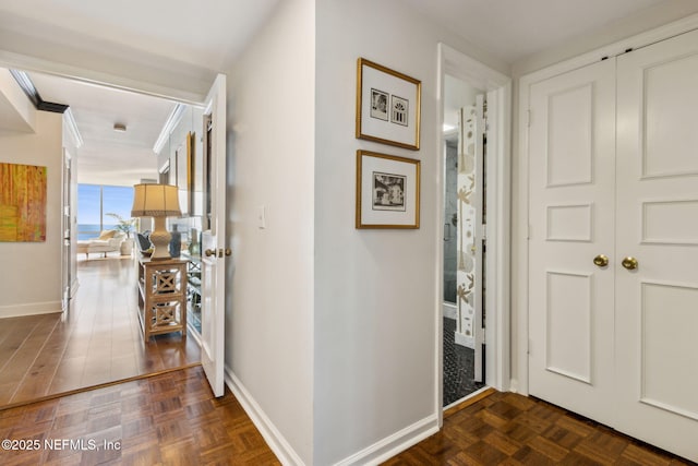 entrance foyer featuring baseboards and ornamental molding