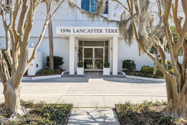 doorway to property with french doors and stucco siding