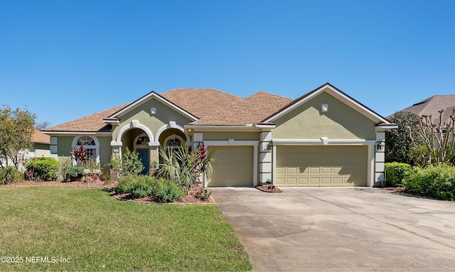 single story home featuring an attached garage, a front yard, concrete driveway, and stucco siding