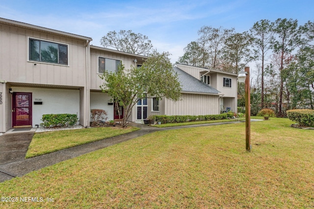 view of property featuring a front lawn