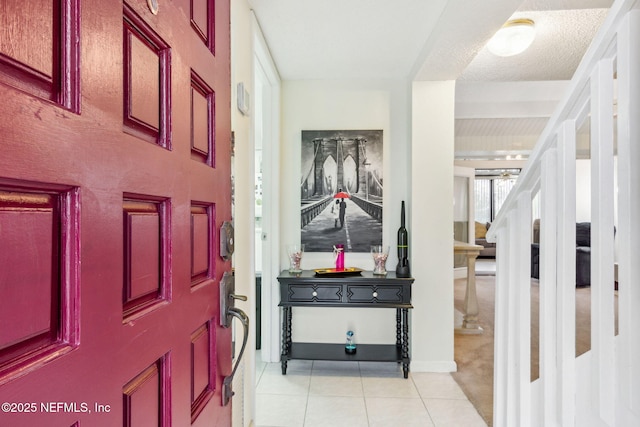 entrance foyer with stairway and light tile patterned floors