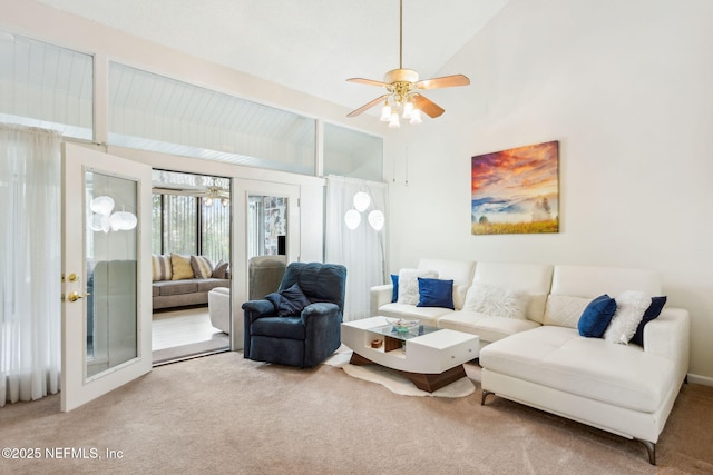 carpeted living room with high vaulted ceiling and a ceiling fan