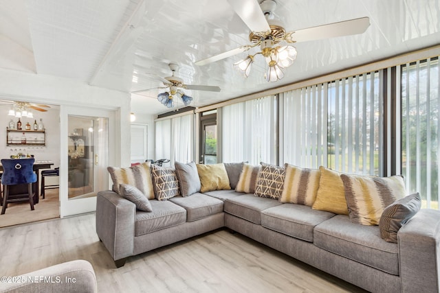 sunroom / solarium with a ceiling fan