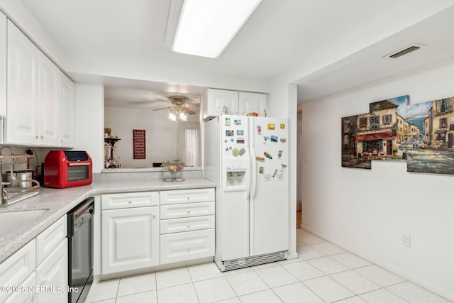 kitchen featuring white refrigerator with ice dispenser, light countertops, visible vents, white cabinetry, and dishwashing machine