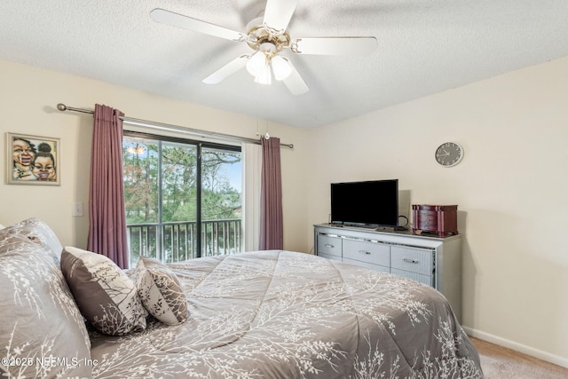 bedroom with a textured ceiling, carpet, baseboards, and access to exterior