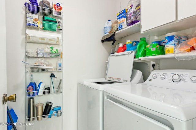 laundry area with cabinet space and washing machine and clothes dryer