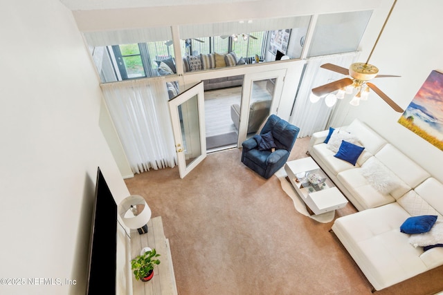 living area with carpet flooring and a ceiling fan