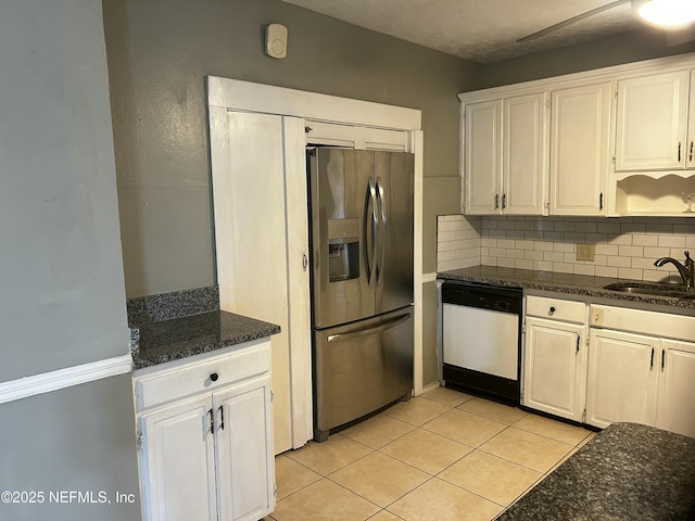 kitchen featuring stainless steel refrigerator with ice dispenser, light tile patterned floors, decorative backsplash, a sink, and dishwasher