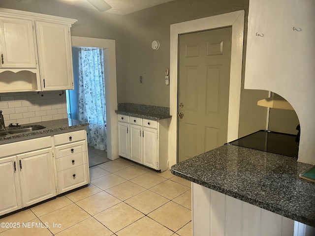 kitchen featuring decorative backsplash, white cabinetry, open shelves, a sink, and light tile patterned flooring