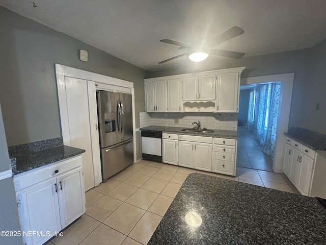 kitchen with stainless steel fridge, decorative backsplash, white cabinets, dishwasher, and a sink