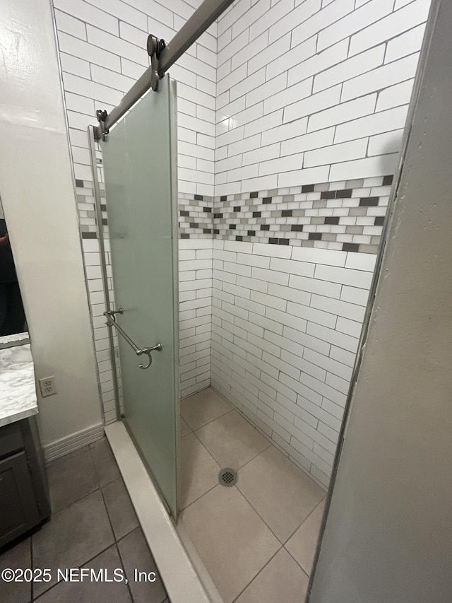 full bathroom with tile patterned floors, a shower stall, and vanity