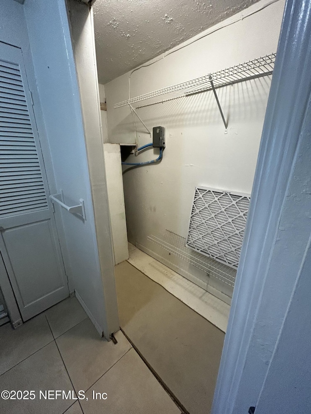 spacious closet featuring tile patterned flooring