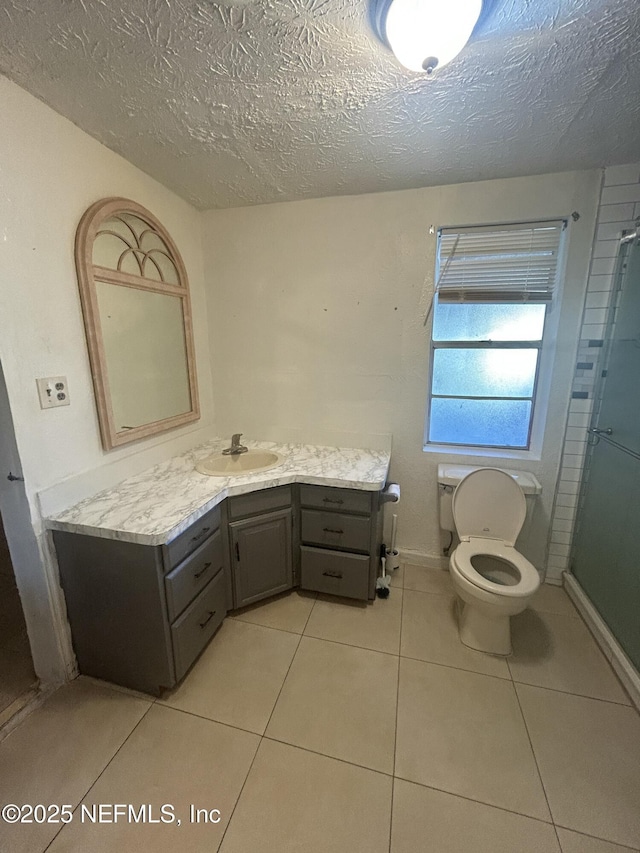 full bath with toilet, vanity, a shower, and tile patterned floors