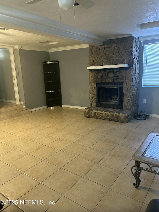 unfurnished living room with a fireplace, a textured ceiling, and tile patterned floors