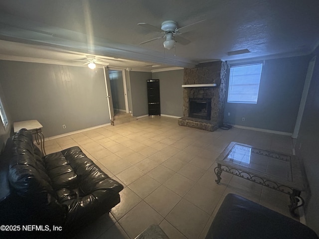 unfurnished living room featuring a ceiling fan, tile patterned flooring, a fireplace, and baseboards