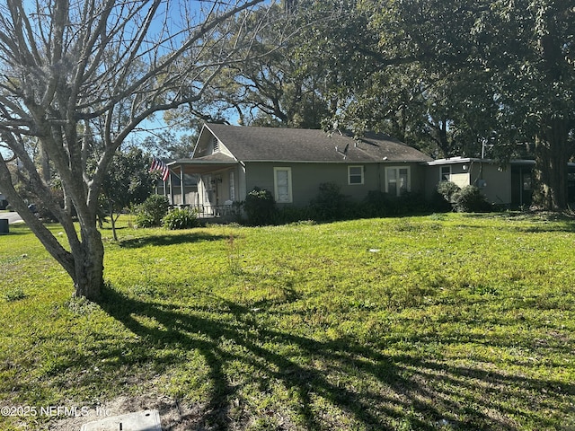 view of side of property featuring a porch and a yard