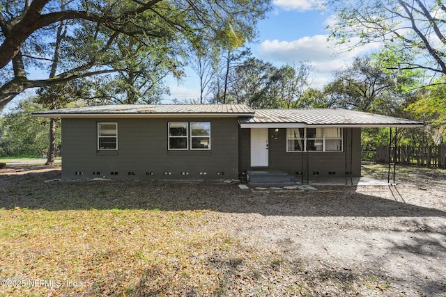 single story home featuring crawl space, metal roof, and fence