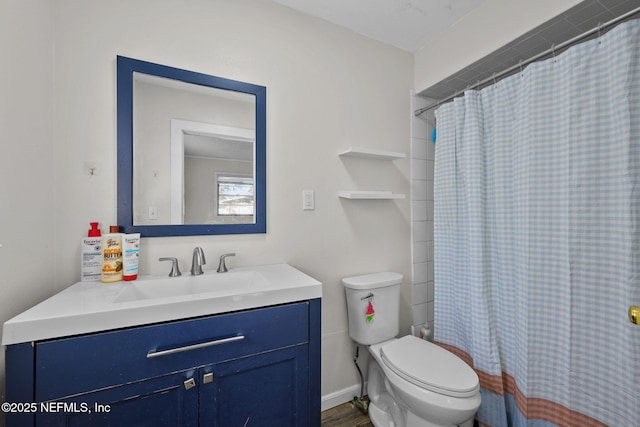 bathroom with toilet, curtained shower, and vanity