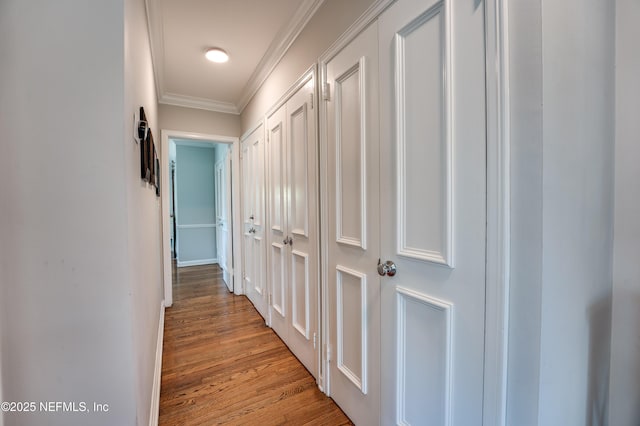 hall with crown molding and light wood finished floors