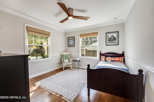 bedroom with baseboards, ornamental molding, ceiling fan, and wood finished floors