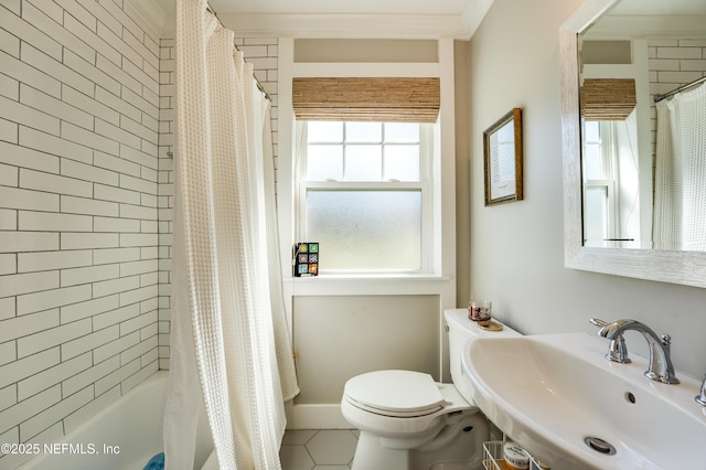 bathroom featuring toilet, tile patterned flooring, a sink, and shower / tub combo with curtain