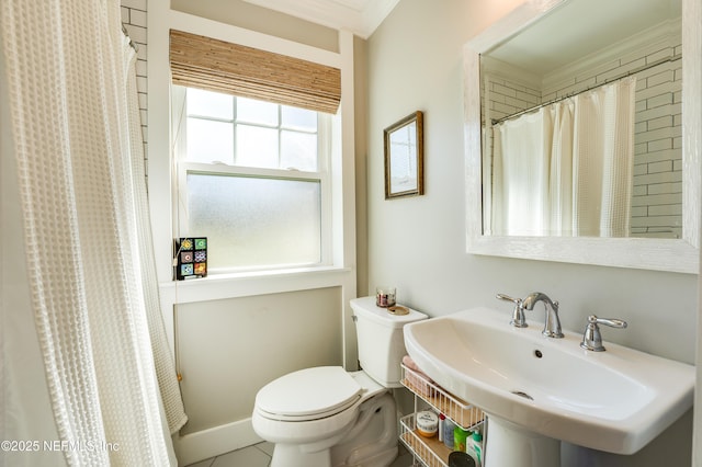 full bathroom with baseboards, a sink, toilet, and tile patterned floors