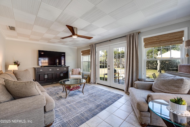 living room featuring a healthy amount of sunlight, light tile patterned floors, visible vents, and french doors