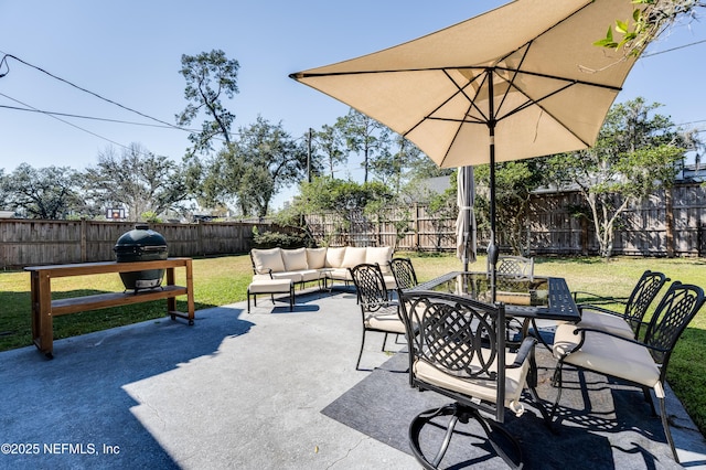 view of patio with outdoor dining space, grilling area, a fenced backyard, and an outdoor living space