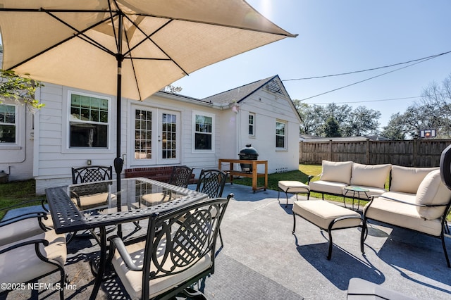 view of patio / terrace with french doors, outdoor dining area, outdoor lounge area, and fence