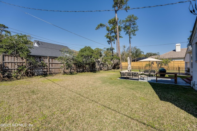 view of yard with a fenced backyard and a patio