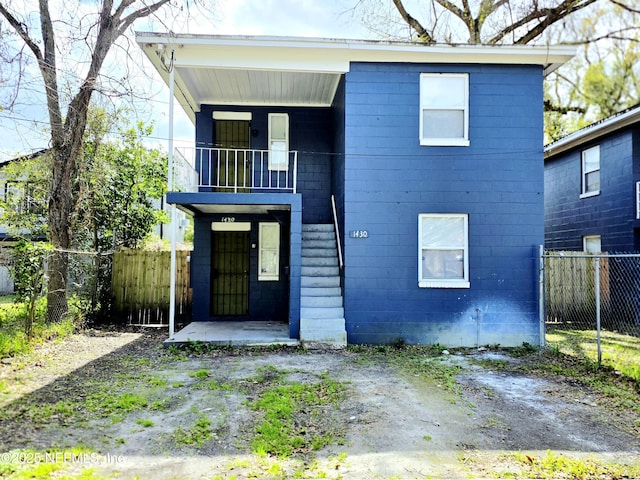 view of front of property featuring fence private yard and concrete block siding