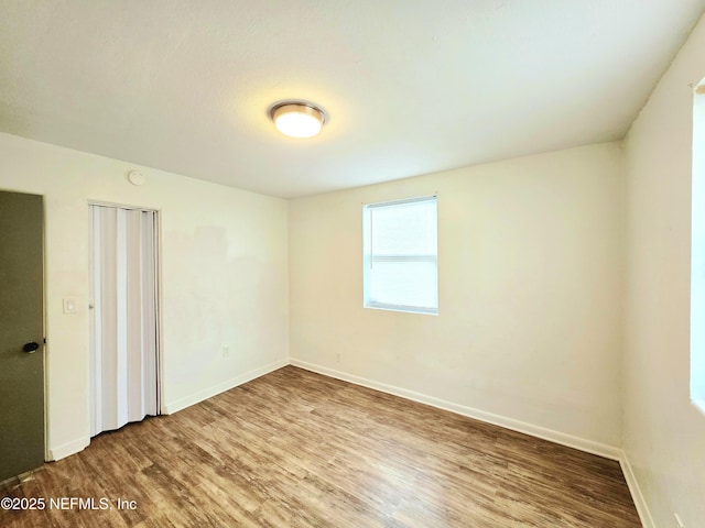 interior space with baseboards and wood finished floors