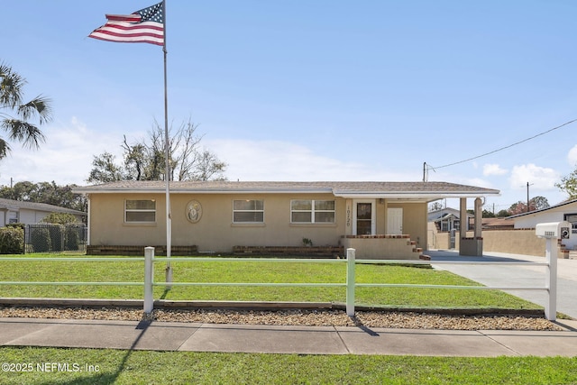 single story home with a front lawn, fence, an attached carport, and stucco siding