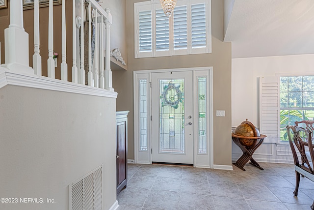 entrance foyer with tile patterned floors, visible vents, and baseboards