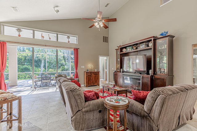 living area with light tile patterned floors, visible vents, lofted ceiling, and a ceiling fan
