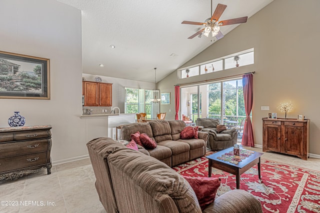 living room with light tile patterned floors, baseboards, high vaulted ceiling, and ceiling fan