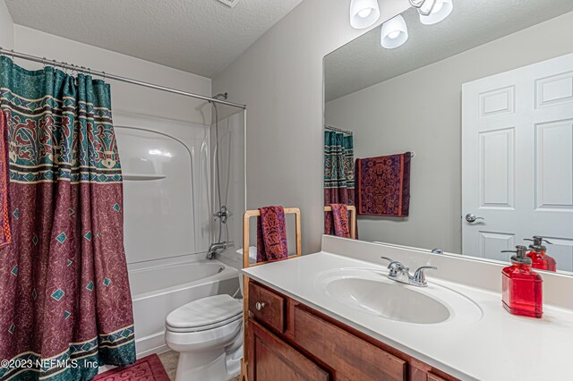 bathroom with shower / bath combination with curtain, toilet, a textured ceiling, and vanity