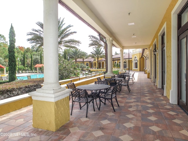 view of patio / terrace featuring an outdoor pool and outdoor dining space