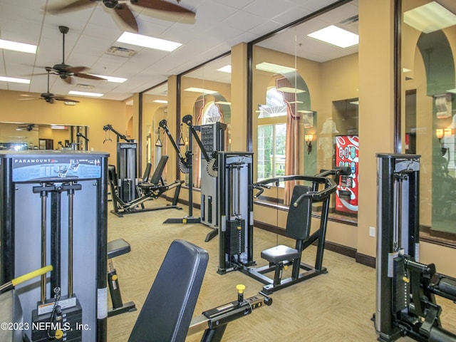 gym featuring visible vents, ceiling fan, carpet, baseboards, and a drop ceiling