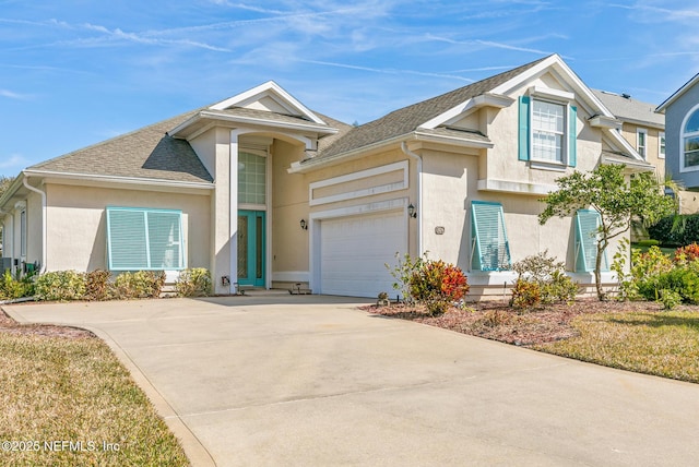 view of front of home with a garage, roof with shingles, concrete driveway, and stucco siding