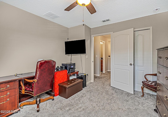 office with ceiling fan, a textured ceiling, carpet flooring, and visible vents