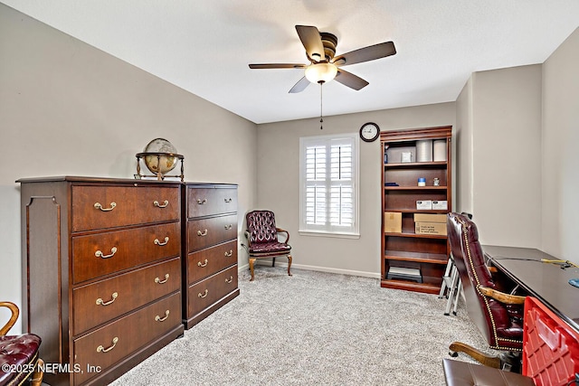 office area with carpet floors, ceiling fan, and baseboards