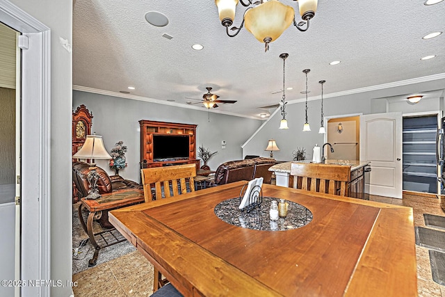 dining room with a textured ceiling, ornamental molding, and a ceiling fan