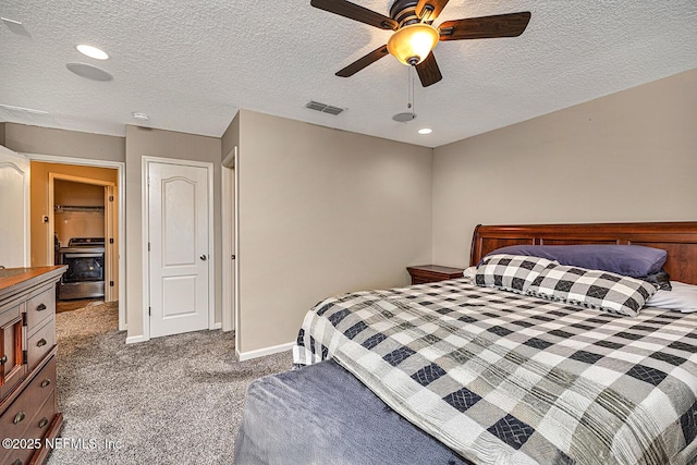 bedroom with a textured ceiling, carpet flooring, a ceiling fan, visible vents, and baseboards